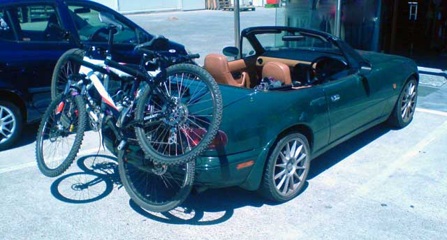 Mazda MX5 with two mountain bikes attached.